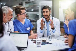 Group of medical professionals discussing at meeting table