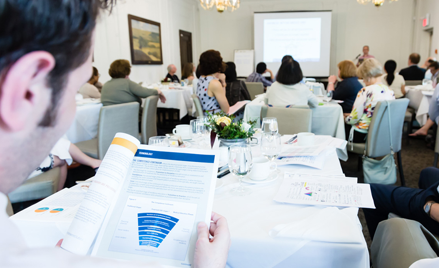 Conference attendee reviews competence continuum during presentation